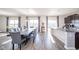 Open kitchen and dining area with granite counters, hardwood floors, and natural light offers a perfect Gathering gathering space at 403 N Crystal Dr, Fortville, IN 46040