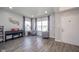 Bright living room with hardwood floors, large windows, and neutral decor provides a warm and inviting ambiance at 403 N Crystal Dr, Fortville, IN 46040