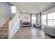 Sun-lit living room with hardwood floors and large windows creates an inviting space for relaxation and entertainment at 403 N Crystal Dr, Fortville, IN 46040
