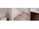 Bathroom with vinyl flooring, toilet, bathtub and sink at 4046 Denali Dr, Indianapolis, IN 46235