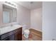 Bathroom features a sink with marble countertop, toilet and a mirror with lighting fixture at 4046 Denali Dr, Indianapolis, IN 46235