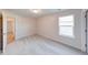 A spacious bedroom featuring soft carpet, a window, and natural light at 4046 Denali Dr, Indianapolis, IN 46235