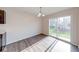 Bright dining area with wood floors, modern lighting, and sliding glass doors to the backyard at 4046 Denali Dr, Indianapolis, IN 46235