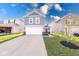 Charming two-story home with a white garage door, gray siding, and a well-manicured lawn at 4046 Denali Dr, Indianapolis, IN 46235