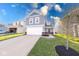 Charming two-story home with a white garage door, gray siding, and a well-manicured lawn at 4046 Denali Dr, Indianapolis, IN 46235