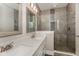 Modern bathroom featuring dual sinks with white countertops, a walk-in glass shower, and decorative tile at 4077 Rookwood Ave, Indianapolis, IN 46208
