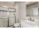 Bathroom features a glass enclosed shower, a white vanity, and a large mirror at 4077 Rookwood Ave, Indianapolis, IN 46208
