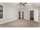A well-lit bedroom with neutral tones, carpeted floor and multiple doors at 4077 Rookwood Ave, Indianapolis, IN 46208