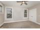 Bright, carpeted bedroom featuring two large windows and a closet at 4077 Rookwood Ave, Indianapolis, IN 46208