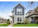 Charming two-story home featuring attractive gray siding, well-maintained landscaping, and a welcoming front entrance at 4077 Rookwood Ave, Indianapolis, IN 46208