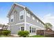 A view of the home's rear featuring tidy landscaping, neutral siding and white trim beneath a clear blue sky at 4077 Rookwood Ave, Indianapolis, IN 46208