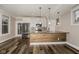 Bright kitchen with stainless appliances, white cabinets and an island with light wood at 4077 Rookwood Ave, Indianapolis, IN 46208
