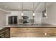 Spacious kitchen featuring a central island with sink, modern lighting and stainless steel appliances at 4077 Rookwood Ave, Indianapolis, IN 46208