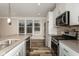 Updated kitchen featuring stainless steel appliances, new cabinetry, tile backsplash and a breakfast bar at 4077 Rookwood Ave, Indianapolis, IN 46208
