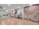 Spacious finished basement with stylish flooring, exposed brick accent wall, and versatile layout for various uses at 4125 Rookwood Ave, Indianapolis, IN 46208