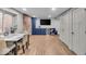 The finished basement is an entertainment hub featuring custom cabinetry, wet bar, mini-fridge, and wall mounted TV at 4125 Rookwood Ave, Indianapolis, IN 46208