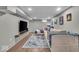 Cozy basement with neutral palette, laminate flooring, tv, sofa, and eye-catching area rug creating a welcoming atmosphere at 4125 Rookwood Ave, Indianapolis, IN 46208