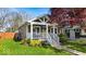 Charming home with a covered porch, beautiful landscaping, and inviting curb appeal at 4125 Rookwood Ave, Indianapolis, IN 46208