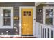 Charming home exterior with bright yellow front door, white trim, and address numbers; welcoming entrance at 4125 Rookwood Ave, Indianapolis, IN 46208