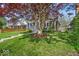 Inviting front yard with mature tree, lush lawn, and charming home exterior, great curb appeal for Gathering and friends at 4125 Rookwood Ave, Indianapolis, IN 46208