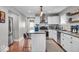 Bright kitchen with stainless steel appliances, white cabinetry, and a functional island at 4125 Rookwood Ave, Indianapolis, IN 46208