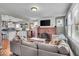 Open-concept living room with a brick fireplace and a view of the kitchen at 4125 Rookwood Ave, Indianapolis, IN 46208