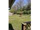 Fenced backyard featuring a well maintained lawn, mature trees, and a vibrant Japanese maple at 4211 Medina Way, Indianapolis, IN 46227