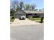 Charming single-story home features a gray brick exterior, well-maintained lawn and a long driveway at 4211 Medina Way, Indianapolis, IN 46227