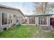 Spacious backyard featuring green grass and access to both the main house and a detached building at 4411 Rotterdam Dr, Indianapolis, IN 46228