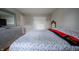 Well-lit bedroom with wood floors, a large dresser, and a comfortable bed with a floral comforter at 4411 Rotterdam Dr, Indianapolis, IN 46228