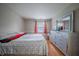 Bright bedroom with a large dresser, mirror, and a bed with a floral-patterned comforter at 4411 Rotterdam Dr, Indianapolis, IN 46228