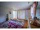 Bedroom featuring wood flooring, matching dresser and mirror, and multiple closets for ample storage at 4411 Rotterdam Dr, Indianapolis, IN 46228