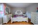 Bright bedroom featuring white furniture set, including a bed with tufted headboard and ornate accents at 4411 Rotterdam Dr, Indianapolis, IN 46228