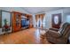 Inviting living room featuring hard wood floors, a large TV, and a comfortable chair at 4411 Rotterdam Dr, Indianapolis, IN 46228