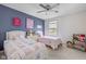 ' bedroom featuring two twin beds, bright paint colors and shelving at 5635 Pennycress Dr, Noblesville, IN 46062