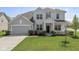 Charming two-story home with a well-manicured lawn and a two-car garage at 5635 Pennycress Dr, Noblesville, IN 46062
