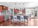 Gourmet kitchen with granite countertops, stainless steel appliances, and breakfast bar seating at 5635 Pennycress Dr, Noblesville, IN 46062
