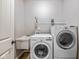 Functional laundry room equipped with washer, dryer, sink, and storage shelf, designed for efficient laundry tasks at 5635 Pennycress Dr, Noblesville, IN 46062