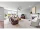 Bright, open living room features large windows, a fireplace, and comfortable seating, creating a welcoming atmosphere at 5635 Pennycress Dr, Noblesville, IN 46062