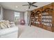 Bright living room with a large bookcase, comfortable seating and natural light at 5635 Pennycress Dr, Noblesville, IN 46062
