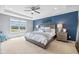 Serene main bedroom with tray ceiling, large window, and elegant furnishings, perfect for relaxation and comfort at 5635 Pennycress Dr, Noblesville, IN 46062
