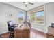 Bright office space with large windows offering neighborhood views, complemented by an elegant wooden desk at 5635 Pennycress Dr, Noblesville, IN 46062