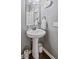 Charming powder room features a pedestal sink, classic fixtures, and a clean design for guest convenience at 5635 Pennycress Dr, Noblesville, IN 46062