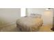 Bedroom with neutral-toned patterned bedding, large window, and a dark floor lamp at 5702 Saratoga Pl, Plainfield, IN 46168