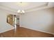 Spacious dining area featuring hardwood floors, a chandelier, and an open layout, perfect for entertaining guests at 5702 Saratoga Pl, Plainfield, IN 46168