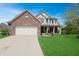 Charming two-story home with a brick facade, attached garage, and a well-manicured lawn, perfect for suburban living at 5702 Saratoga Pl, Plainfield, IN 46168