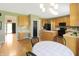 Open kitchen and dining area with wooden cabinets, black appliances, and a view of the backyard at 5702 Saratoga Pl, Plainfield, IN 46168