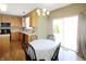 Eat-in kitchen area with wooden cabinets, black appliances, and sliding glass doors leading to the outdoor space at 5702 Saratoga Pl, Plainfield, IN 46168