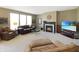 Cozy living room with a fireplace, large windows, and comfortable seating, perfect for relaxing or entertaining guests at 5702 Saratoga Pl, Plainfield, IN 46168
