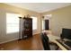 Inviting home office with natural light and hardwood floors; equipped with a bookshelf and a comfortable workspace at 5702 Saratoga Pl, Plainfield, IN 46168